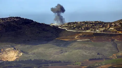 AFP Smoke billows over the southern Lebanese town of Odaysseh during Israeli bombardment (20 January 2024)