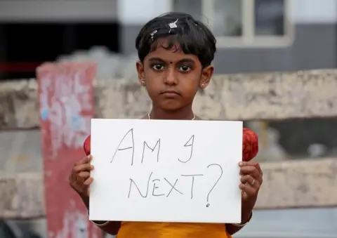 Reuters girl holds a placard during a protest against the rape of an eight-year-old girl in Kathua, near Jammu, in Kochi, India April 15, 2018.