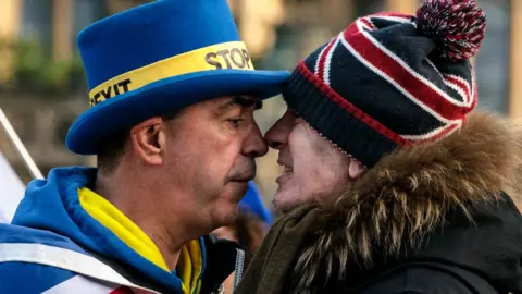 Getty Images Anti-Brexit protester Steve Bray (L) and a pro-Brexit protester argue as they demonstrate outside the Houses of Parliament in Westminster