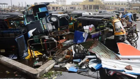 Getty Images Damaged auto rickshaws are pictured in a pile in Puri, 4 May 2019