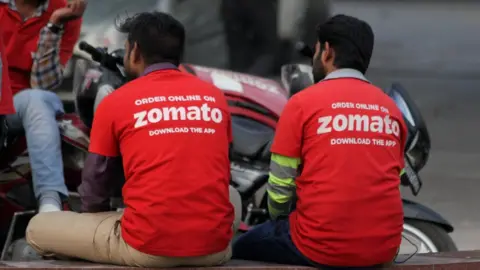NurPhoto/Getty Two Zomato delivery drivers