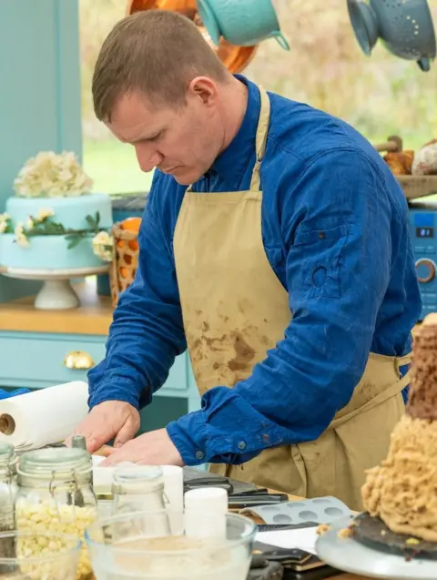 Channel 4 New Bake Off contestant Dan in action