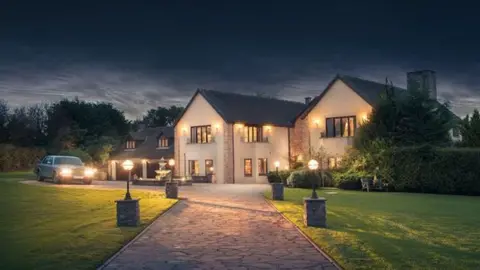 Astley Media Millionaire mansion at night