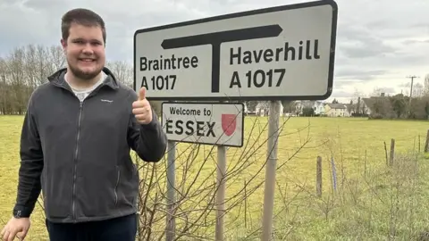 Emma Church Kireon Wicks at one of the Welcome to Essex signs