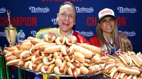 PA Media Joey Chestnut from Indiana (L) and Miki Sudo from Florida (R) with hot dogs