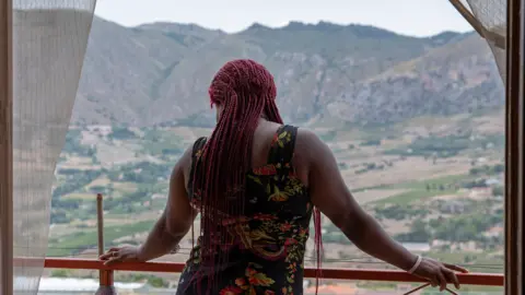 Kate Stanworth A Nigerian woman at a shelter for trafficked women in Sicily, Italy
