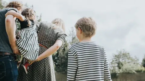 Getty Images Boy watching family