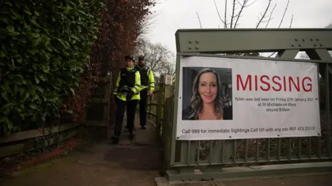 PA Media A poster for Nicola Bulley on a footbridge over the River Wyre