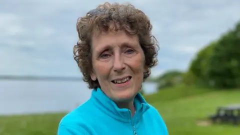 BBC News A woman smiles in to the camera.