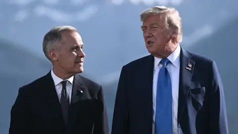 Getty Images Mark Carney standing with Donald Trump