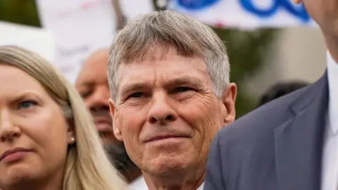 Reuters Former U.S. Olympic canoeist David Hearn stands with his lawyer as they speak to reporters following Hearn’s arraignment on a charge related to “vandalizing” the Lincoln Memorial Reflecting Pool, at DC Superior Court in Washington, D.C., U.S., 9 July 2026