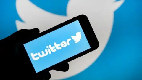 Getty Images The Twitter logo displayed on a phone screen