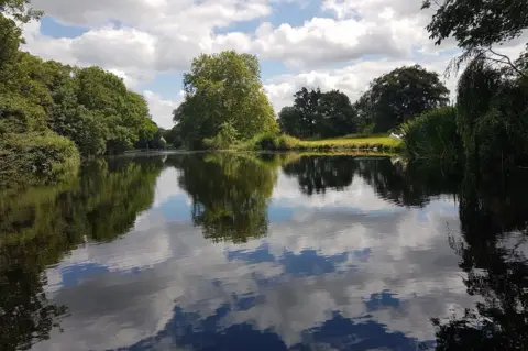 Caroline Turner Clouds reflected in a pond