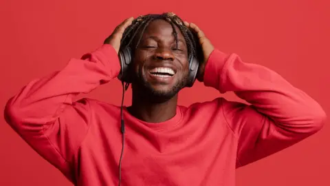Getty Images Man listening to music