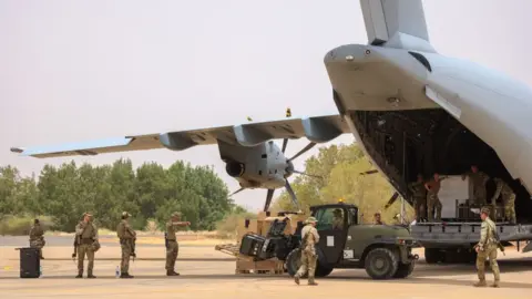 Getty Images UK military personnel unloading stores for British nationals on Tuesday