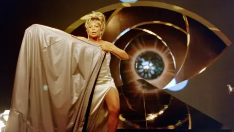 Getty Images Tina Turner poses for a James Bond style photo shoot at Pinewood Studios in London. She sang the theme song for the 1995 Bond film 'GoldenEye'.