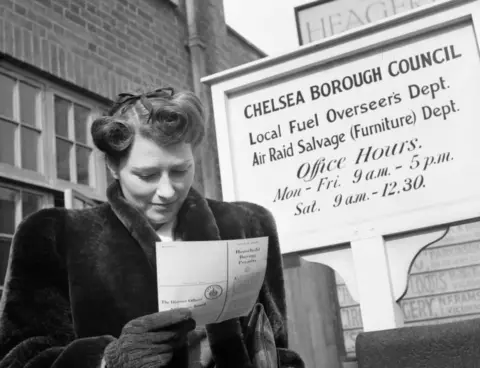 IWM/Getty Images War Bride: Everyday Life In Wartime London, March 1943, Newly-engaged Marcelle Lestrange looks at her permit for Utility furniture which she has just received from Chelsea Borough Council, March 1943. (Photo by Ministry of Information Photo Division Photographer/ Imperial War Museums via Getty Images)