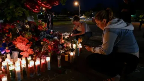 Getty Images Residents held a candlelight vigil on Sunday near the site of the shooting