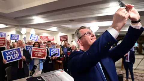 Pacemaker Sir Jeffrey Donaldson takes a selfie with party members at the local government manifesto launch