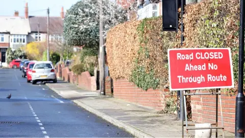 BBC Residential street in Jesmond with road closure sign