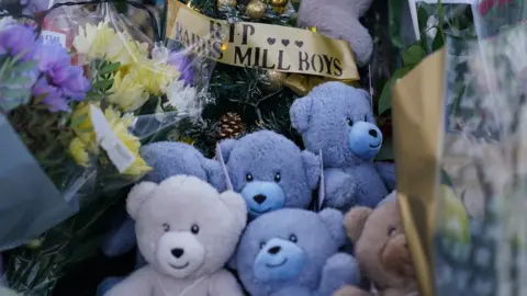 Getty Images Teddies and a sign saying the Babbs Mill Boys