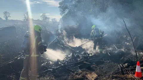 Gloucestershire Fire Fire officers tackling the blaze