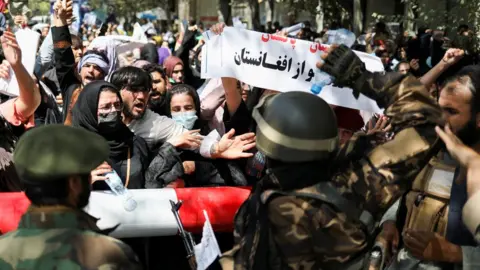 Reuters Taliban soldiers stand in front of protesters during the anti-Pakistan protest in Kabul