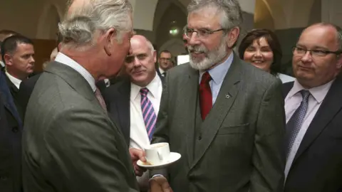 REUTERS/Brian Lawless/pool GALWAY, IRELAND - MAY 19: Prince Charles, Prince Of Wales shakes (shaking, handshake shake) hands with Sinn Fein president Gerry Adams at the National University of Ireland on May 19, 2015 in Galway, Ireland.