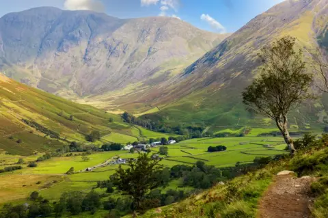 Getty Images View of a valley surrounded by large hills