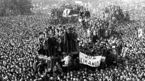 Reuters Romanian demonstrators gather in front of the headquarters of the Romanian Communist Party in Bucharest, Romania, on 22 December 1989