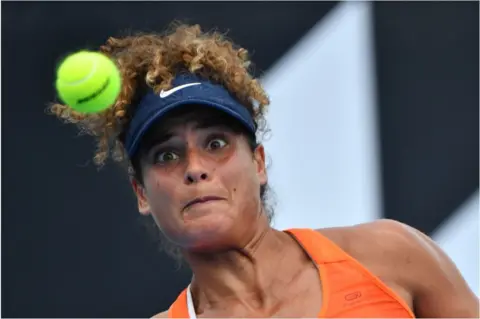 AFP Mayar Sherif stares intently at the ball as she hits a return.