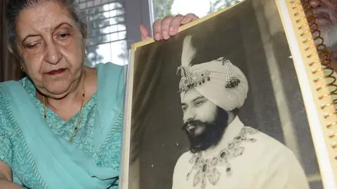 Getty Images Amrit Kaur, the daughter of the late Maharaja of Faridkot- Harinder Singh Brar, poses with a portrait of the Maharaja at her residence in Chandigarh on August 2, 2013
