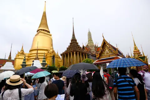 Getty Images A Chinese tourist group visits the Emerald Buddha Temple inside the Grand Palace in Bangkok, Thailand, 23 September 2017