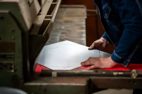 File image of a person working with a sheet of aluminium