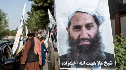 Getty Images A poster of Taliban Supreme Leader Hibatullah Akhundzada is seen along a road in Kabul on 14 August 2023