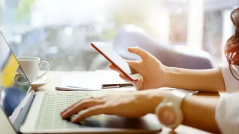 Getty Images Woman holding a phone