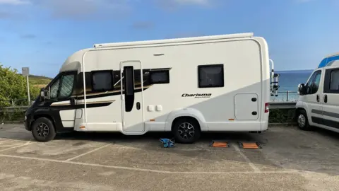 Motor home parked across three spaces