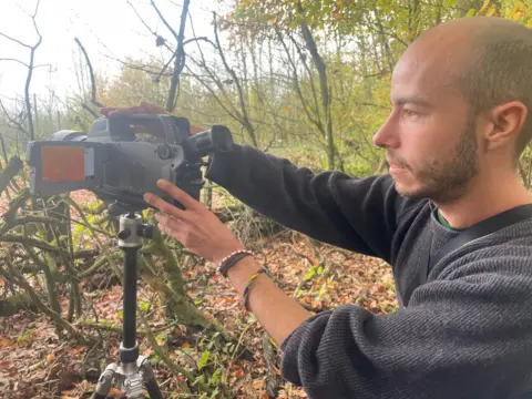 BBC/Gwyndaf Hughes Man with gas imaging camera.