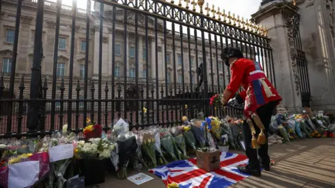 Reuters Flowers and tributes left outside Buckingham Palace