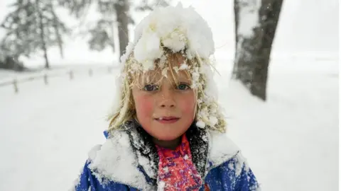 Getty Images A child enjoys the snow in Yosemite National Park