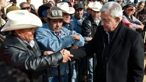 Getty Images Mexican President Andres Manuel Lopez Obrador visits residents of La Mora