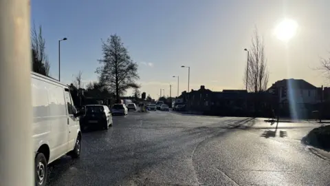 Cars and vans driving along a Cambridge road