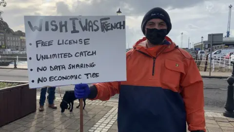 BBC A fisherman holding a sign protesting the post-brexit rows