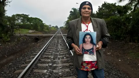 Encarni Pindado Pilar Escobar Medina holds up a photograph of her daughter Olga, who she last saw in 2009