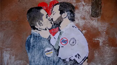 Reuters A mural depicting Northern League's leader Matteo Salvini (R) and 5-Star Movement leader Luigi Di Maio kissing is seen in Rome,