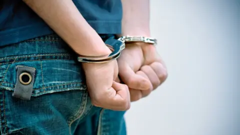 Getty Images Teenager under arrest