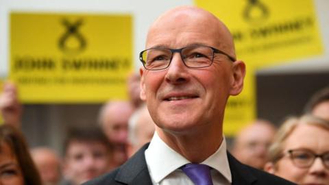 John Swinney reacts after delivering a speech to announce his intentions of running for the SNP leadership as well as his candidacy for the Scotland's First Minister position, during a press statement at the Grassmarket Community Project, in Edinburgh, on May 2, 2024