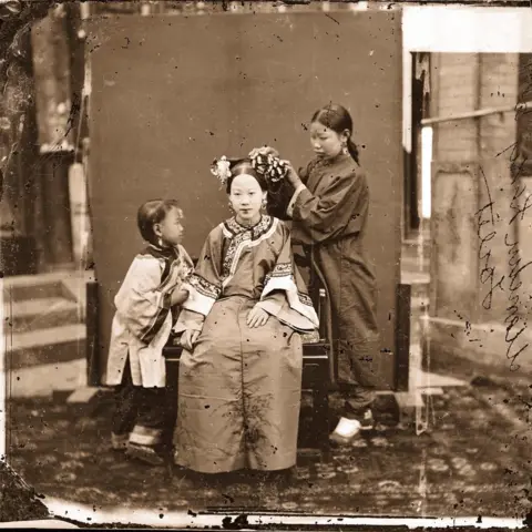 Wellcome Collection, London A Manchu Lady having her Hair dressed by a Servant Girl - Beijing 1871–72