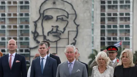 Reuters Prince Charles and Camilla standing near an image of late revolutionary hero Ernesto "Che" Guevara