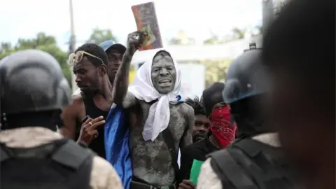 Reuters Demonstrators face police during protests demanding that the government of Prime Minister Ariel Henry do more to address gang violence including constant kidnappings, in Port-au-Prince, Haiti March 29, 2022